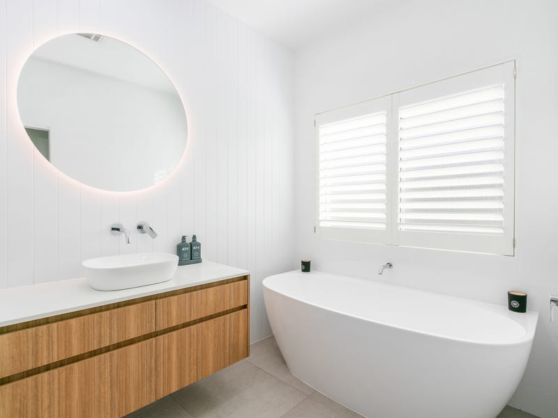Stylish bathroom at 10AirStayz featuring premium fixtures and a walk-in shower