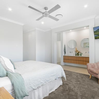 Master bedroom at 10AirStayz with comfortable bedding and natural light